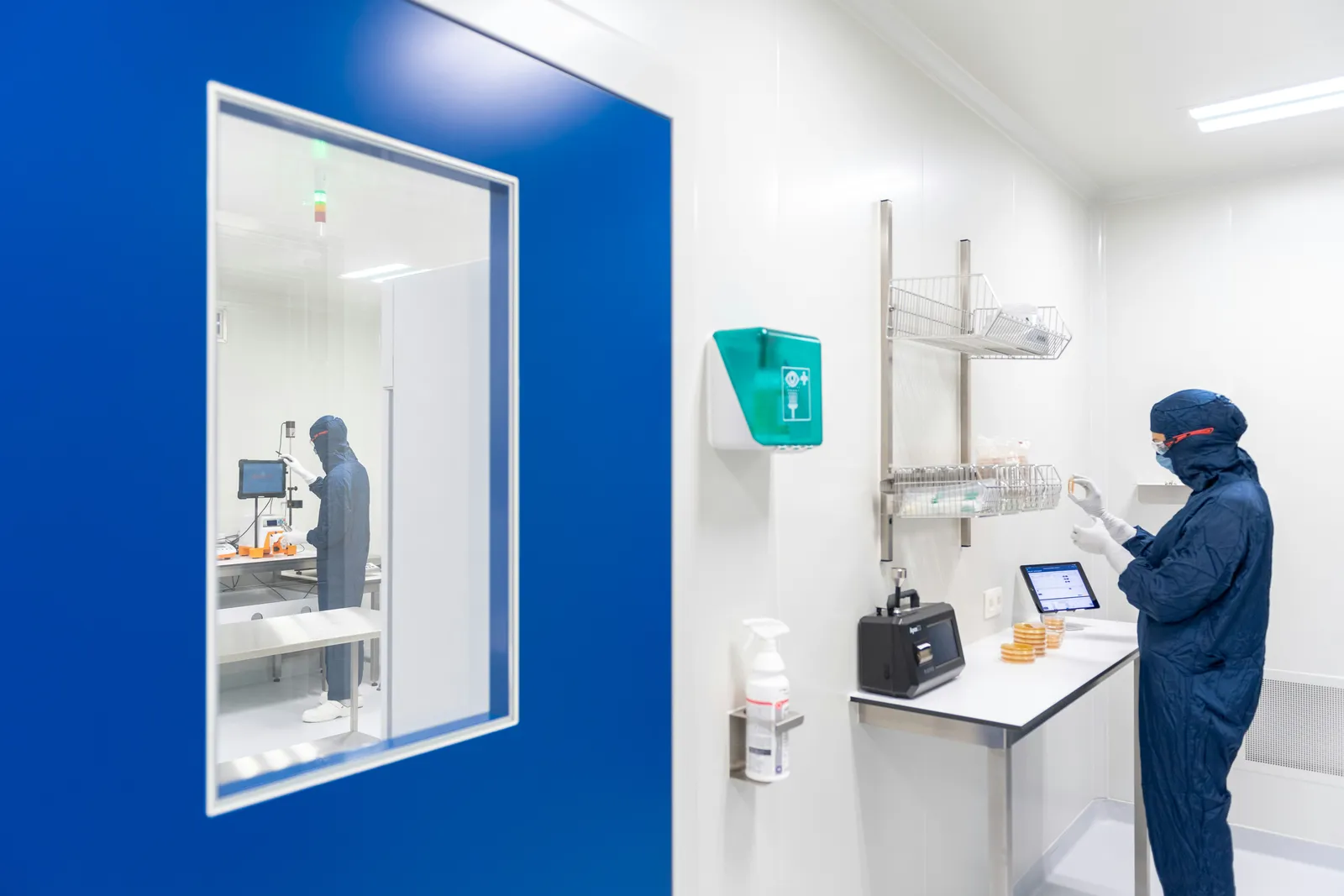 Technician working inside a controlled cleanroom environment