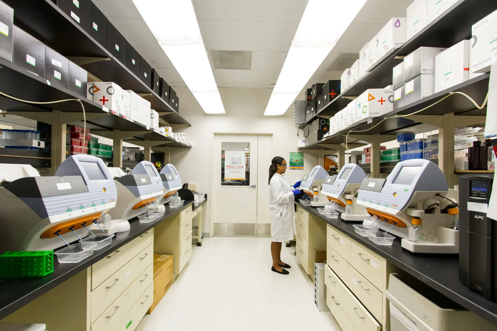 Scientist working in a laboratory with RFID-tracked equipment